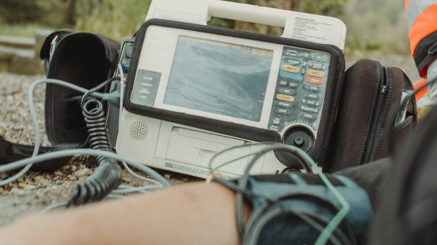 istock Paramedic team checking EKG monitor while performing a CPR on a patient 1241802286