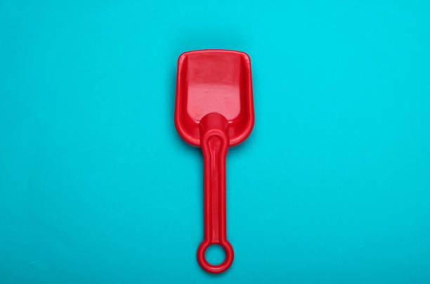 toy shovel on sand in day time