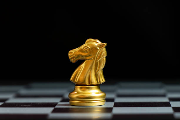 istock Gold knightchess piece stand on black background (Concept for leadership, unique) 1241810985