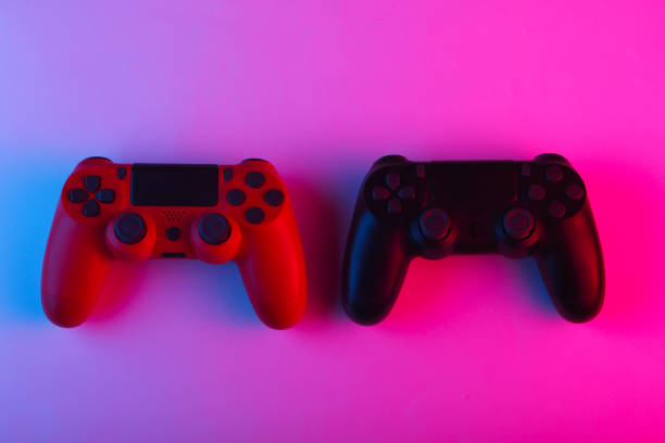 istock Two Gamepads with neon blue-pink light. Gaming concept. 1241812077