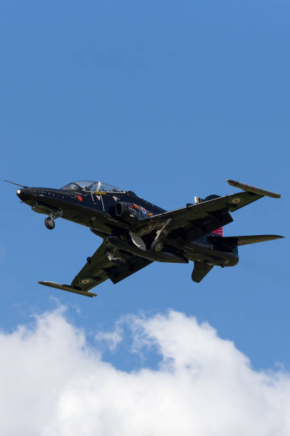 Royal Air Force (RAF) BAE Systems Hawk T.2 on approach to land at RAF Fairford. RAF Fairford, Gloucestershire, UK - July 11, 2014: Royal Air Force (RAF) BAE Systems Hawk T.2 advanced jet trainer aircraft ZK018 from IV(R) Squadron based at RAF Valley on approach to land at RAF Fairford. british aerospace stock pictures, royalty-free photos & images