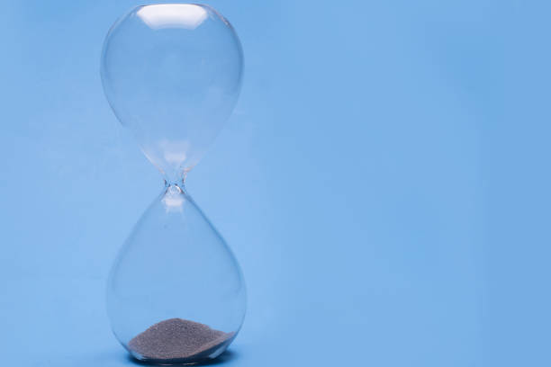 istock Hour glass on a blue backgrrounf 1241821439