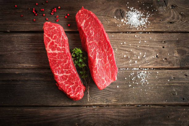 raw Denver steak on wooden background