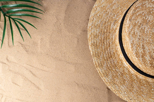 istock Summer vacation composition. Hat on sand background with a copy of space. Summer background 1241845235