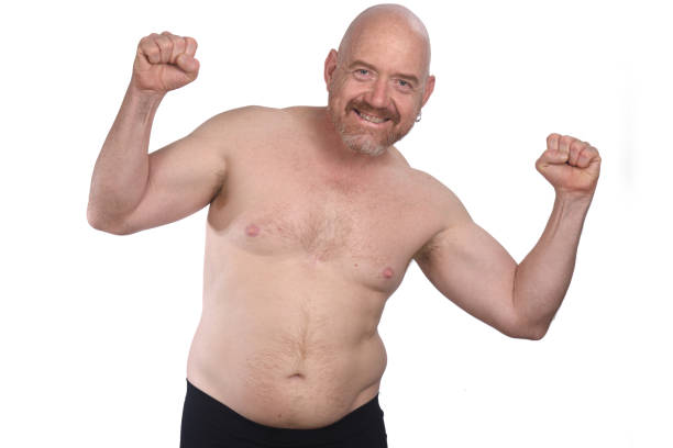 Portrait of a middle aged man shirtless man arms up on white background fat guy no shirt stock pictures, royalty-free photos & images