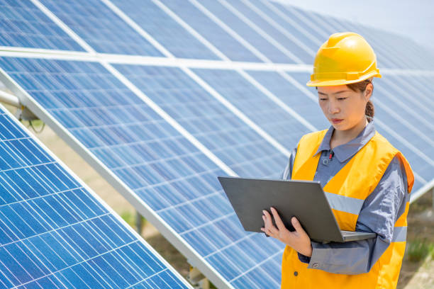 istock Asian female power engineer working at solar power station 1241859270