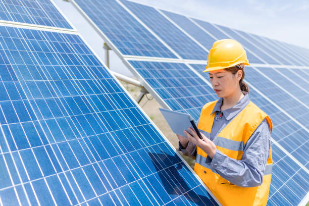 istock Asian female power engineer working at solar power station 1241861427