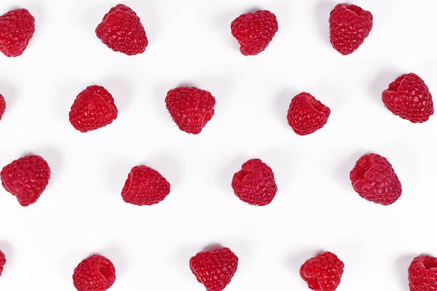 istock Top view of fresh ripe raspberry fruits lined up in rows on white background 1241868381