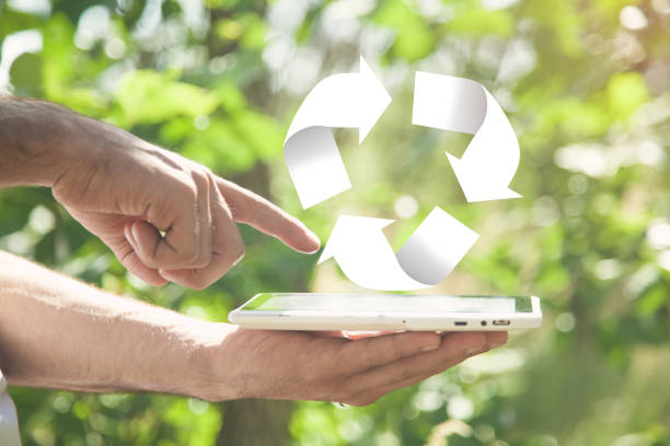 istock Man holding tablet and Recycling symbol in nature. 1241868919