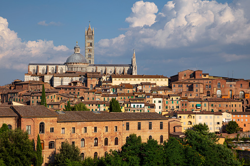 Aerial cityscape image of medieval city of Siena, Italy during sunny day.