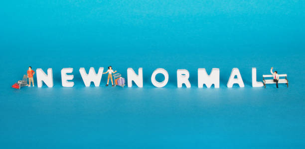 istock Plastic model, travelers wearing a mask, standing at a distance between the plastic characters arranged in new normal text, blue background 1241900949