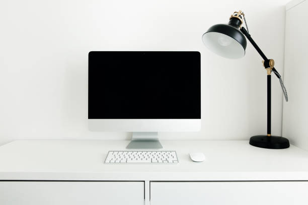 istock White desktop with black monitor and desk lamp. Workplace concept. Mock up blank computer screen with keyboard. Minimalism in the interior. 1241900956