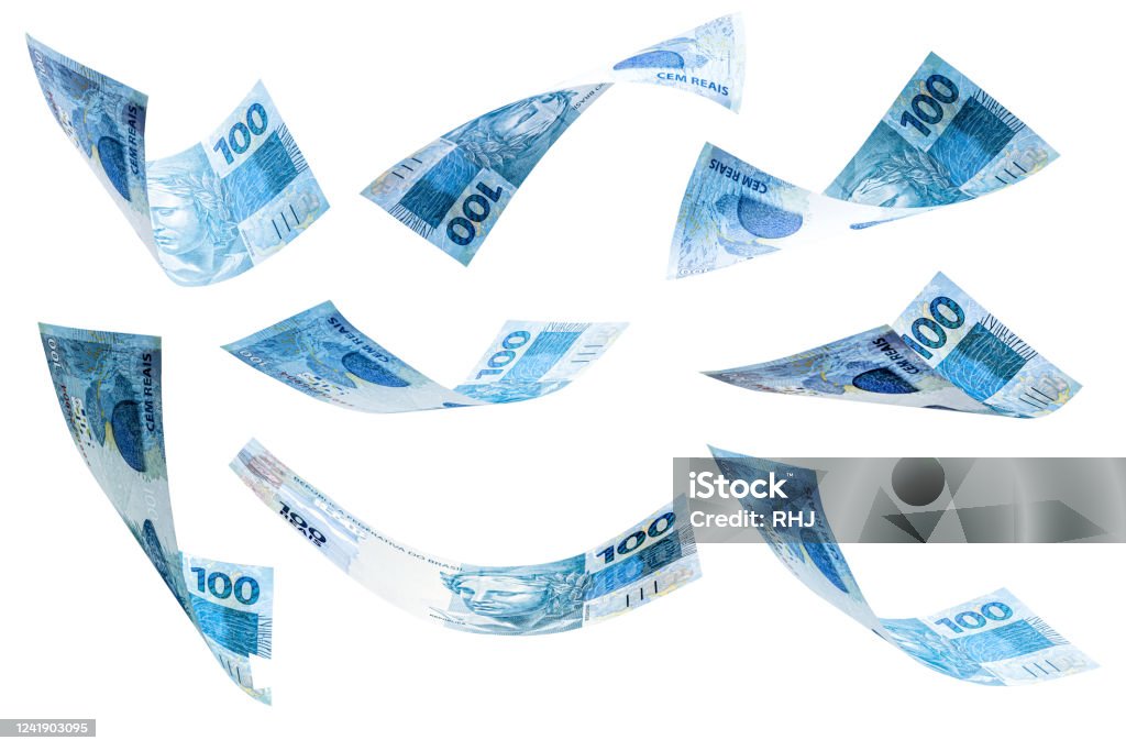 banknotes of 100 reais of brazil falling on isolated white background. Grand prize, lottery or wealth concept. Paper Currency Stock Photo