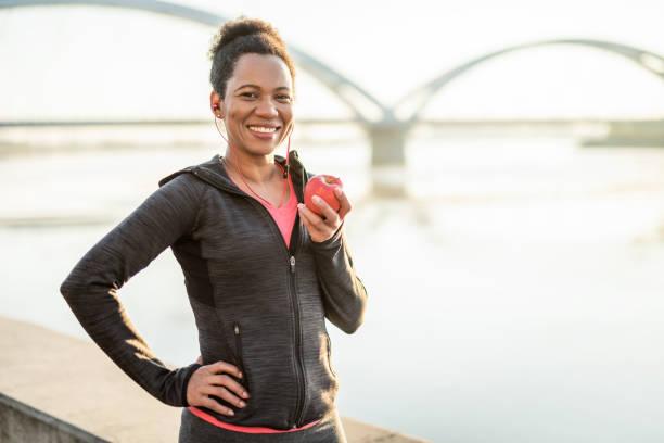 istock Sporty Woman Eating an Apple. 1241904186