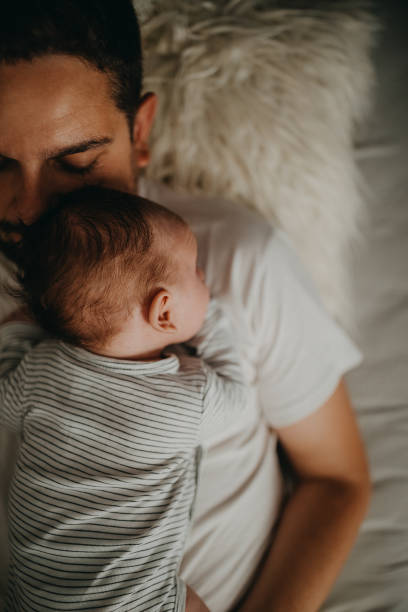 istock Father embracing his baby son in bedroom 1241909744