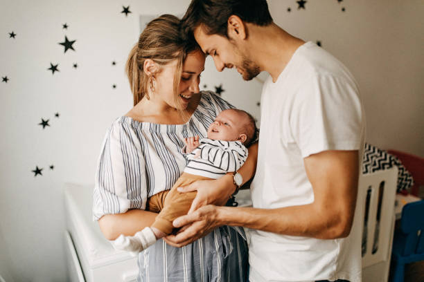 istock Parents holding their baby 1241917744