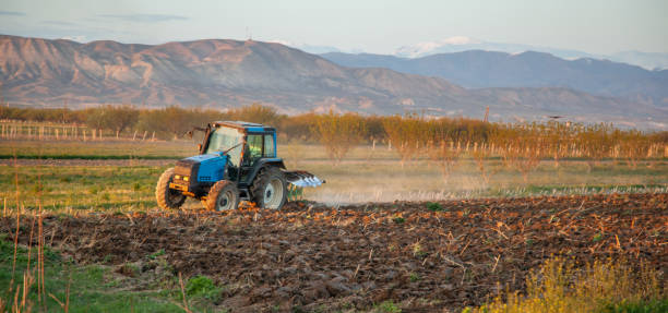istock tractor in the field 1241928377