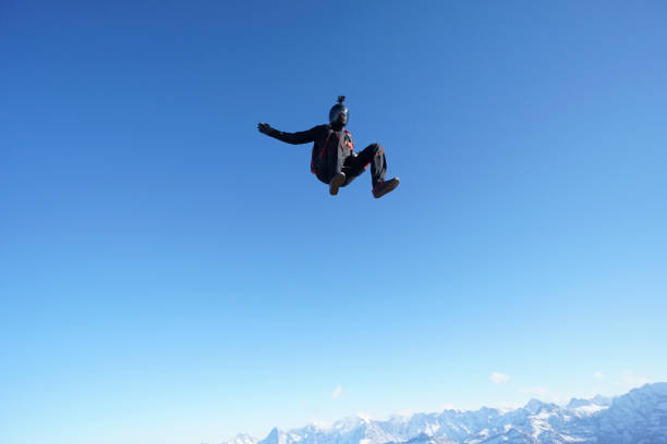 istock Skydiver falls through clear skies, aerial flight 1241932120