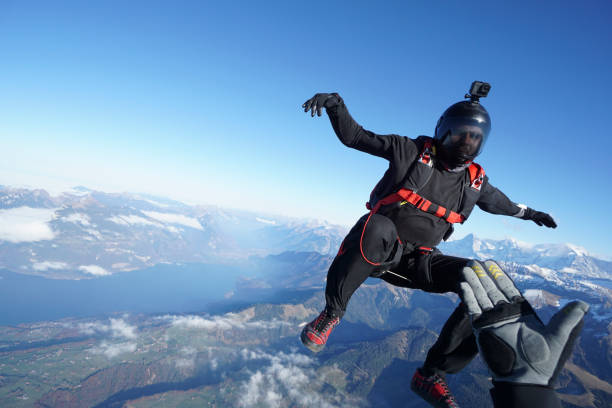 istock Skydivers fall through clear skies, aerial flight 1241936480