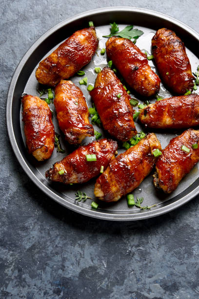 istock Bacon wrapped grilled chicken wings 1241938108