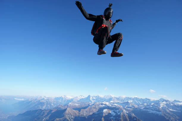 istock Skydiver falls through clear skies, aerial flight 1241939212