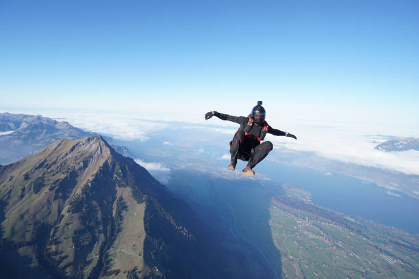 istock Skydiver falls through clear skies, aerial flight 1241939760