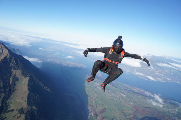 istock Skydiver falls through clear skies, aerial flight 1241944131