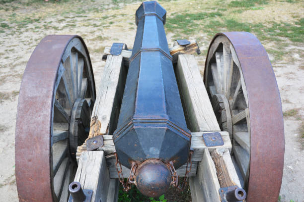 istock Cast iron cannon, artillery weapon on two wooden wheels. 1241946989