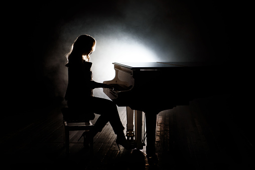 Pianist musician piano music playing. Musical instrument grand piano with woman performer.