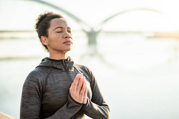 istock Woman Meditating on Sunrise. 1241950832
