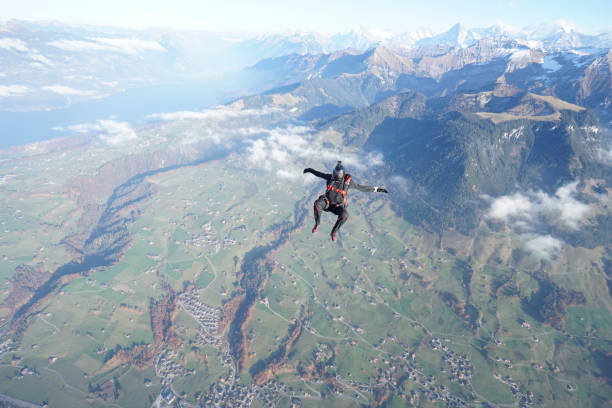istock Skydiver falls through clear skies, aerial flight 1241955168