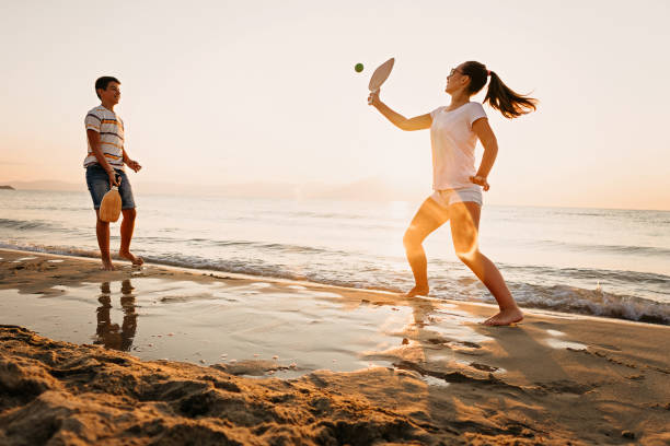 istock Friends playing beach tennis 1241969165