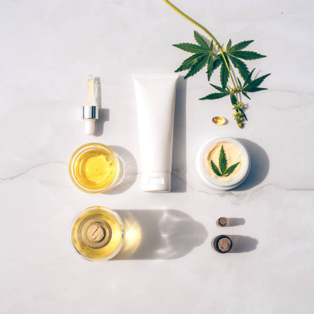 Cosmetics CBD oil. Cosmetic Products with cannabis Oil, tincture Flat lay Tuba and jar of cream CBD oil, THC tincture and hemp leaves on marble background. Flat lay, minimalism. Cosmetics CBD oil. Cream with hemp oil and marijuana leaves hemp photos stock pictures, royalty-free photos & images