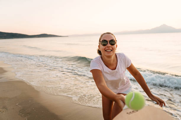 istock Girl playing beach tennis 1241974246