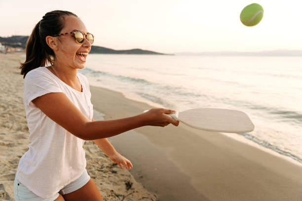 istock Girl playing beach tennis 1241974795