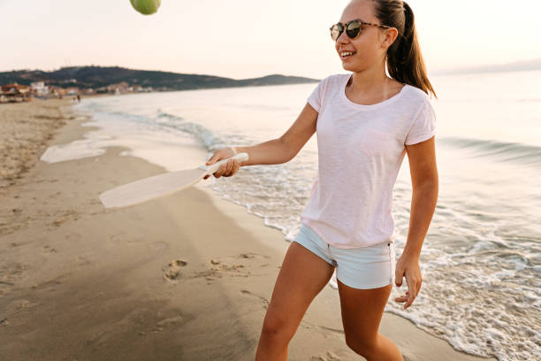 istock Girl playing beach tennis 1241975358