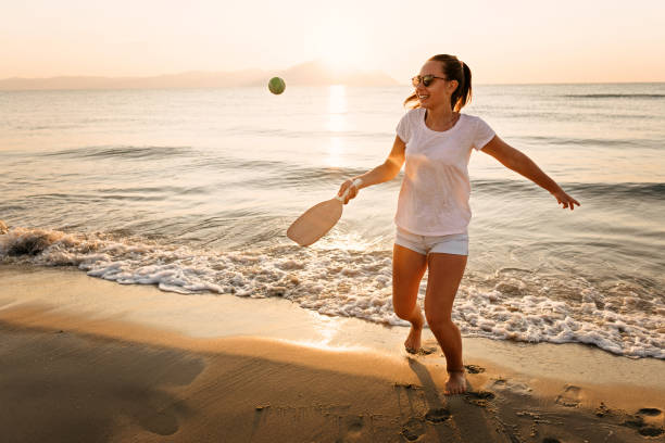 istock Girl playing beach tennis 1241975936