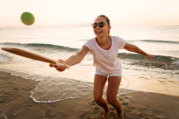 istock Girl playing beach tennis 1241976476
