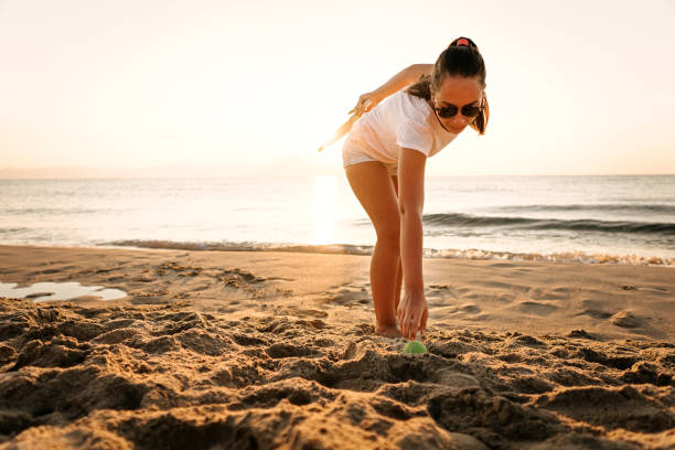 istock Girl playing beach tennis 1241976844