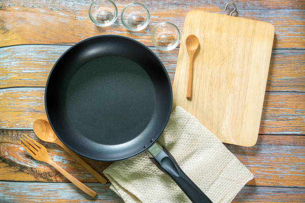 istock Cast iron pan and other kitchen utensils on a dark brown aged background, top view 1241986749