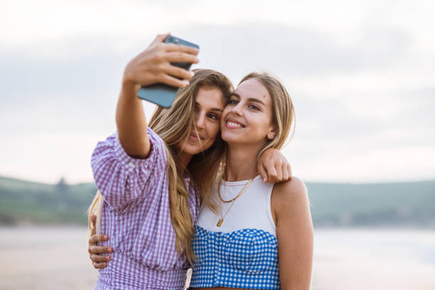 istock Two young women taking a selfie picture together 1241987846