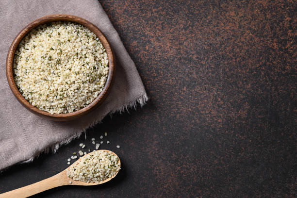 istock Kernels hemp in wooden bowl on brown.View from above. 1241993285
