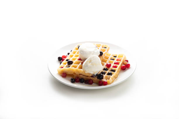 Plate with delicious waffles with berries and ice cream. Isolated on white background