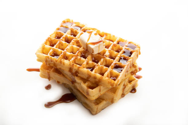 istock Delicious Belgian waffles with caramel topping isolated on a white background 1242001519
