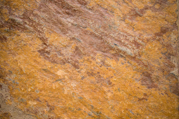 istock Orange rough textured stone background 1242018942