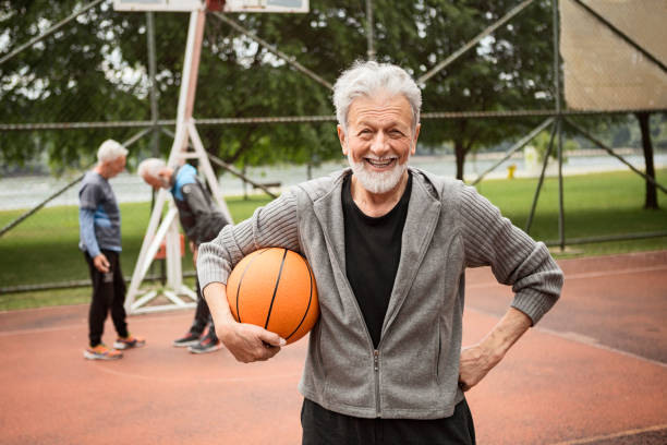 istock Active senior man posing on basketball court 1242020523