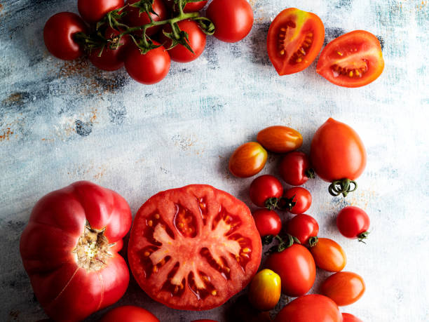 Fresh tomatoes, Tomato,  Set of fresh whole and sliced tomatoes, Colorful ripe tomato, Tomato, Slice of Food, Heirloom Tomato, food and drink, Variation, Vegetable, High Angle View, Leaf, Bunch, tomatoes, Agriculture, Branch - Plant Part,Slice of Food, tomato plant photos stock pictures, royalty-free photos & images