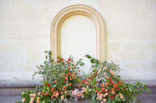 wedding flower arch near an old wall