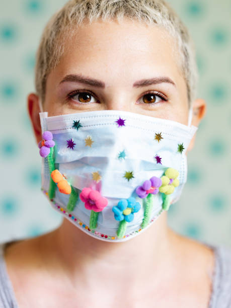 istock Young woman with artsy face mask 1242029059