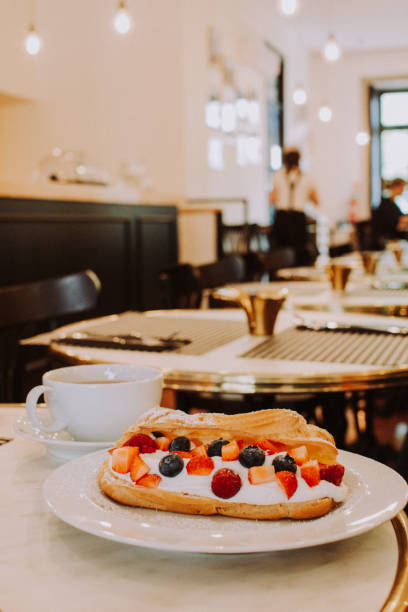 istock Eclair with berries and coffee in a beautiful interior 1242030592